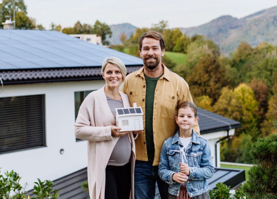 A family outside their home with rooftop solar